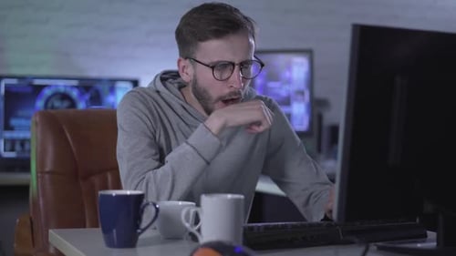 Man Typing On Computer Then Taking Off Glasses