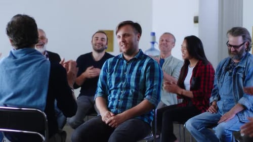 Supportive Group Applauds Speaker in Meeting