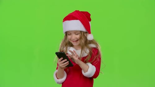 Kid Girl in an Embrace Photographed on a Smartphone. Green Screen