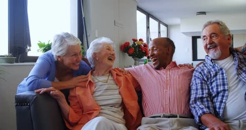 Cheerful Seniors Laughing Together Indoors in Bright Setting