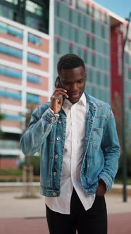 Black Man Speaking on Smartphone in City