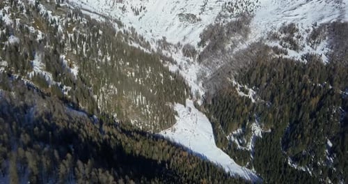 Aerial drone view of snow covered mountains in the winter.