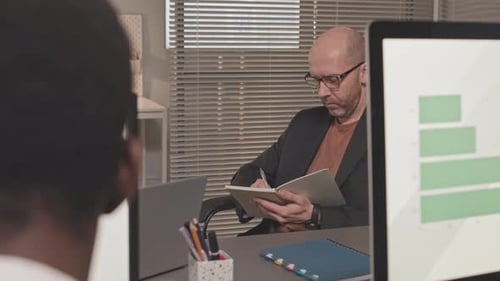 Businessman Taking Notes in Notebook