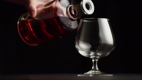 Brandy Being Poured from a Bottle to a Glass