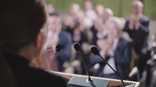 Woman Giving Speech at Corporate Event to Audience