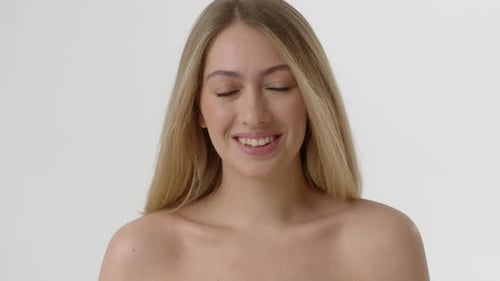 Beautiful Young Woman Smiling Confidently in Studio