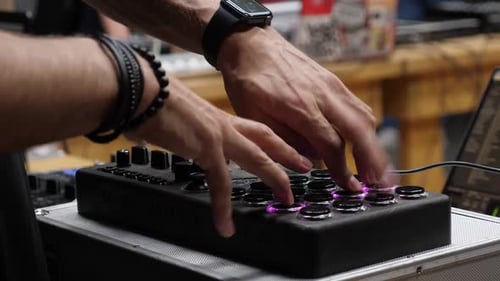 Hands Operate MIDI Controller with Glowing Buttons