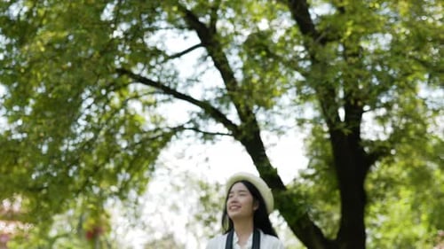 Smiling Woman Taking Photos in Sunny Park