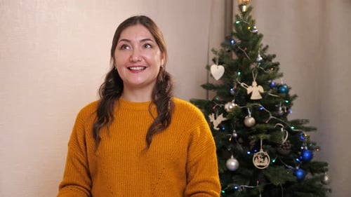 Cheerful Woman Presents Christmas Gift in Cozy Home