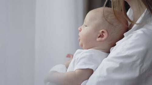 Close Up of Young Mother Holding on Hands Her Baby Son