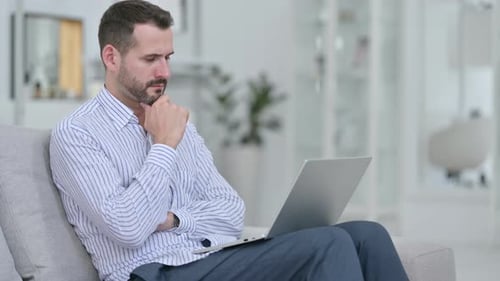Man Working on Laptop at Home Office