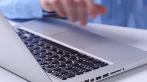 Making Online Bank Transfers, Man's Hand Holds a Credit Card While Entering Data in Laptop. Close Up