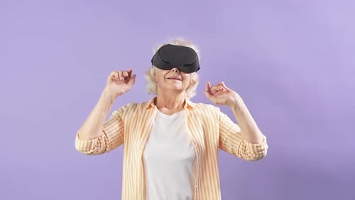 Mature Woman Wearing VR Headset, Gesturing