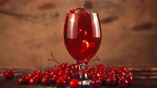 Wine Glass Filled with Red Liquid and Cherries