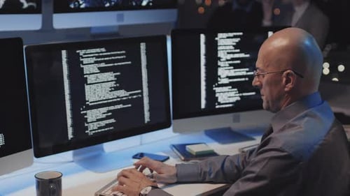 Bold Man Coding in Office at Night