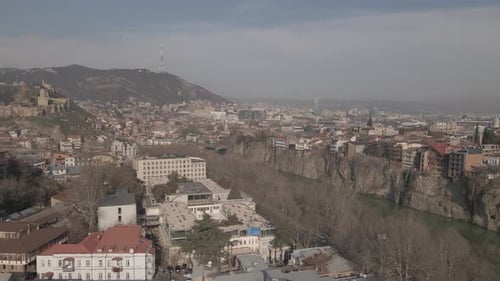Aerial view of Metekhi church in old Tbilisi located on cliff near river Kura. Georgia 2021 winter