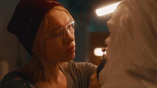 Craftswoman Polishing Plaster Bust in Workshop