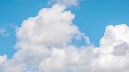 Fluffy White Clouds Drifting on a Sunny Day