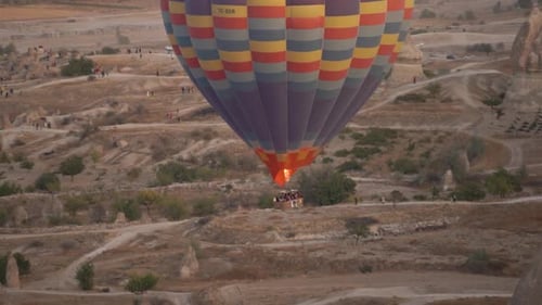 Hot Air Ballooning Over a Desert Landscape at Sunset