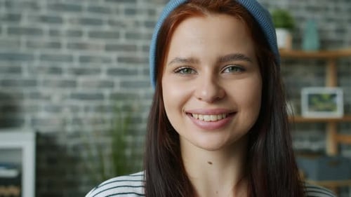 Close-up Slow Motion Portrait of Cheerful Girl Wearing Hat Smiling Looking at Camera