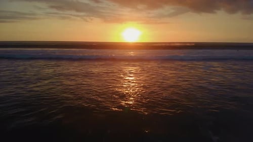 Flight at Sunset Overlooking the Indian Ocean in Bali Indonesia
