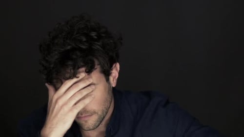 Upset man holding head