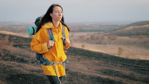 Woman Traveler with Backpack Walking in the Mountains, Freedom and Happiness. Active Sport Lifestyle