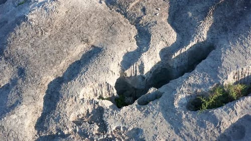 Erosion von nacktem, faltigem Gestein mit Löchern - Textur eines rauen Steins mit gefurchter Oberfläche