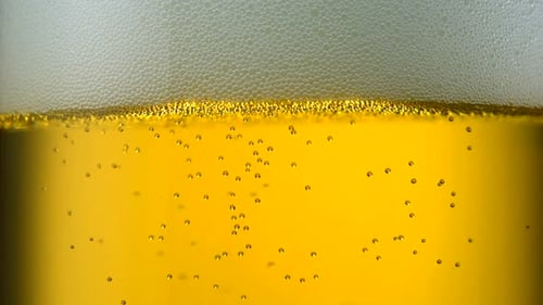 Extreme close-up beer bubbles in glass, Slow Motion