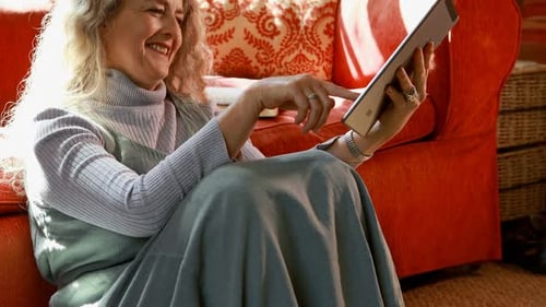 Woman Sitting Using a Tablet Device Indoors