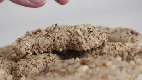 Hand Takes Nut Cookie from Pile