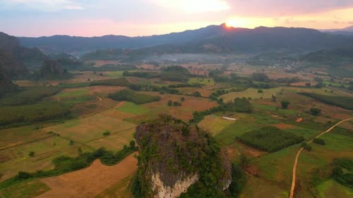 Aerial view from a drone over a misty landscape that covers the farmland