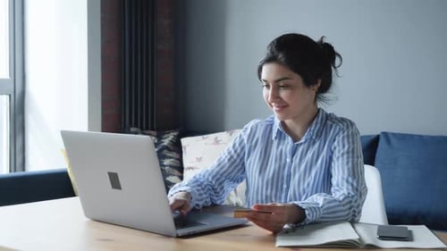 Woman Shopping Online at Laptop with Credit Card