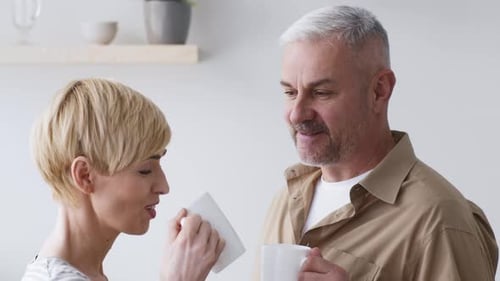 Mature Couple Enjoying Coffee Together Indoors