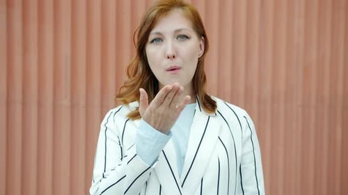 Cheerful Woman Blowing a Kiss to the Camera