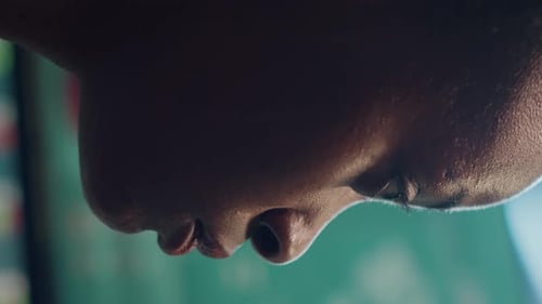 Close Up of Face with Stock Market Display