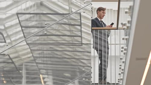Professional Man Using Cell Phone in Modern Building