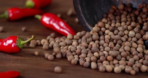 Chili Peppers and Allspice on Wooden Table
