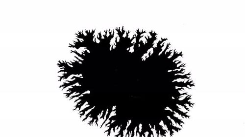 Black Ink Blot Expanding on White Surface