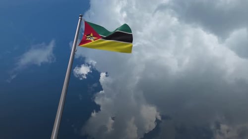 Mozambique National Flag Waving Against Dramatic Sky