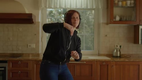 Happy Young Adult Woman Dancing in the Kitchen in Slow Motion