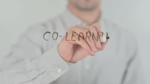 Adult Writes Co-Learning on Clear Surface with Marker