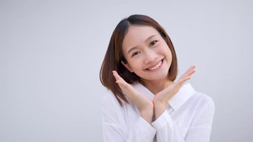 Smiling Woman Holding Hands Up to Face