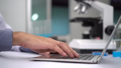Scientist Working on Laptop in Lab