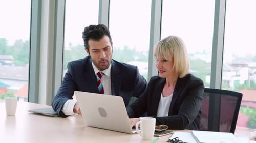 Two Business People Talk Project Strategy at Office