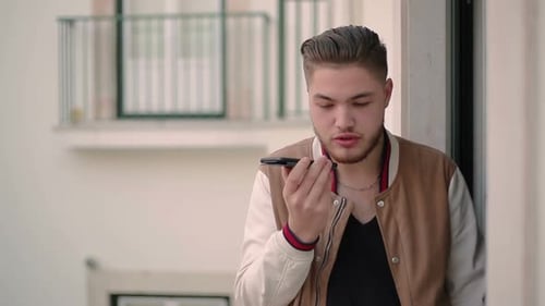 Young Adult Recording Voice Message on Mobile Phone