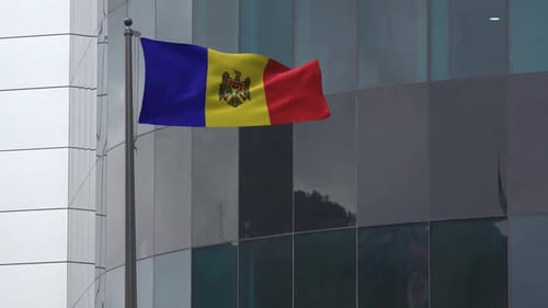 Moldova National Flag Waving Realistically in Front of Modern Building