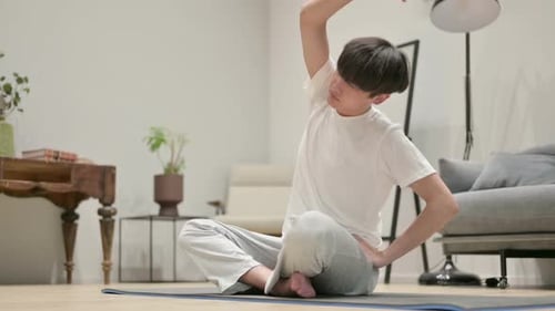 Young Adult Stretching in Brightly Lit Home