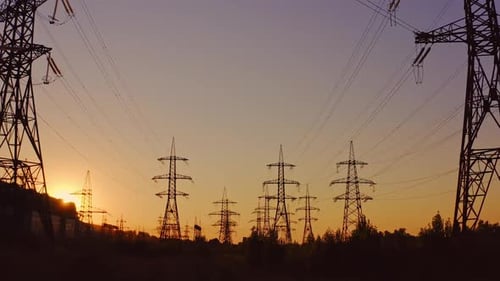 Silhouette of high-voltage towers. Electricity pylons on energy station