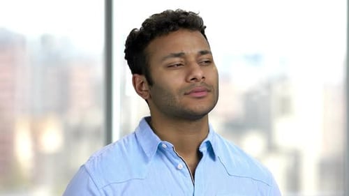 Close Up of Pensive Businessman on Blurred Background.
